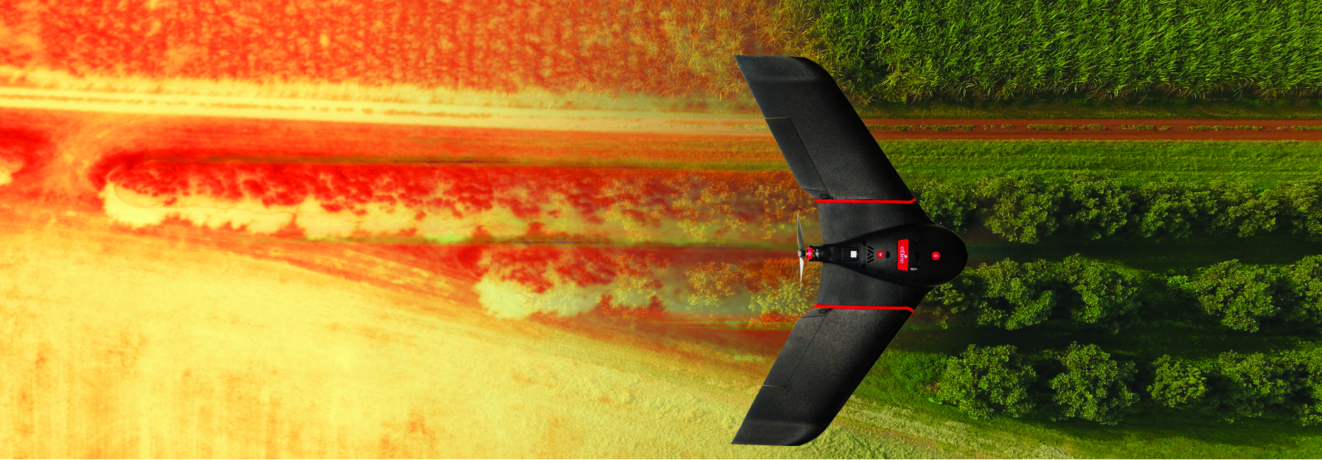 Red fixed-wing drone flying over field aerial imagery of farm